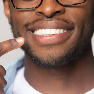 Young man showing off his great smile with his new dentures